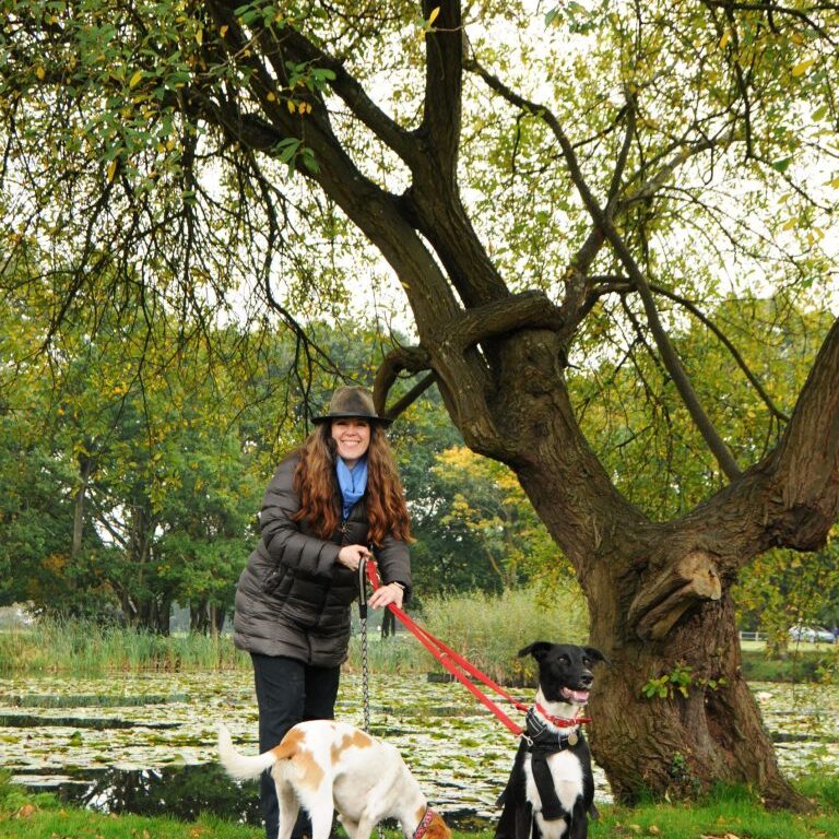 Dog trainer Niki French dog training rescue puppy dogs Bodie and Ruby on lead by tree